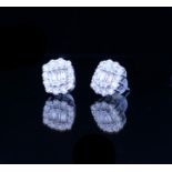 A PAIR OF 18CT WHITE GOLD AND 1CT DIAMOND EARRINGS A baguette cut diamond edged with brilliant round