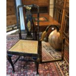 AN EARLY 20TH CENTURY JAPANNED LACQUERED MIRROR Along with a matching cane seated standard chair. (