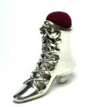A SILVER NOVELTY BOOT FORM PIN CUSHION Victorian design with red velvet cushion. (approx 3cm)