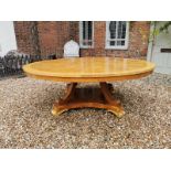 A LARGE REGENCY STYLE POLLARD OAK BREAKFAST TABLE The circular top raised on four scrolling supports