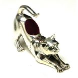 A STERLING SILVER NOVELTY 'STRETCHING CAT' PIN CUSHION' Having red velvet cushion. (approx 5cm)