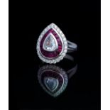 AN 18CT WHITE GOLD, DIAMOND AND RUBY CLUSTER RING The central rose cut diamond edged with a row of