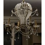 A CONTINENTAL GILT METAL AND CRYSTAL FOUR BRANCH BALLOON CHANDELIER Hung with prisms and numerous