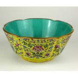 A CHINESE FLORAL DECORATED BOWL On a yellow ground with turquoise interior, bearing seal mark. (