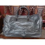 GUCCI, A LARGE BLACK FABRIC HOLDALL BAG Having a black leather carry handle and monogram pattern (