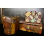 A VINTAGE LEATHER HAT BOX Along with two suit vases, bearing numerous labels.