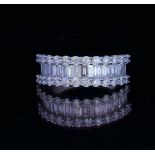 AN 18CT WHITE GOLD AND 2CT DIAMOND RING The row of baguette cut diamonds edged with brilliant