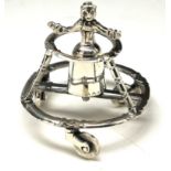 A DUTCH SILVER NOVELTY FIGURE Maiden wearing period clothing with circular walking frame. (approx