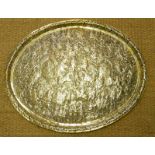A LARGE EARLY 20TH CENTURY INDIAN BRASS OVAL CHARGER Finely chased decoration of 'Vanaras and demons