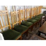 A SET OF EIGHT EDWARDIAN HONEY OAK DINING CHAIRS With green velvet upholstery.