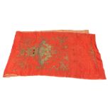 A CHINESE EMBROIDERED SILK PANEL Gilt thread work of dragon and pearl on orange silk ground. (approx