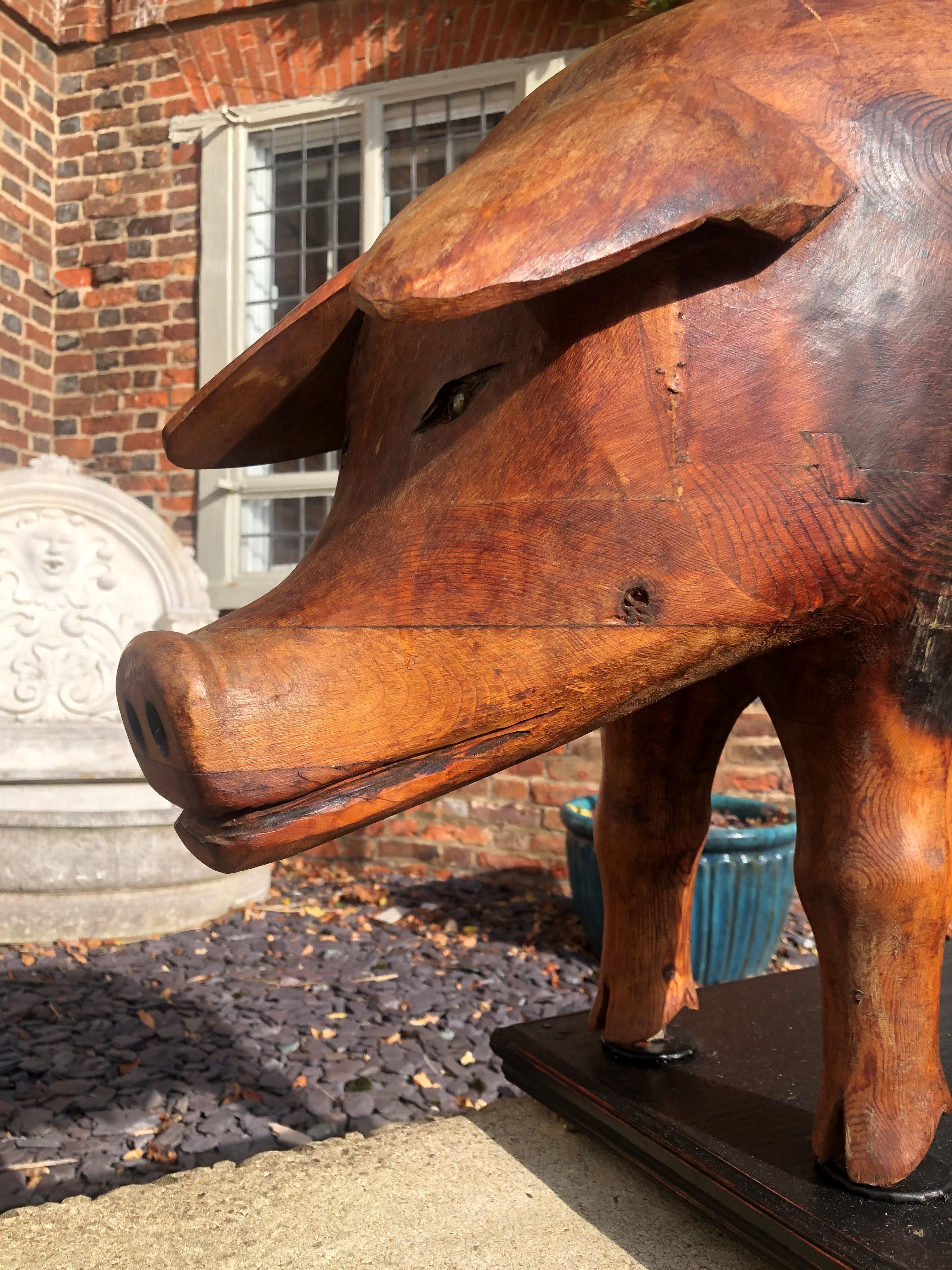 A LARGE CARVED PINE FOLK ART STATUE OF A SOW On later stand. (80cm x 56cm) - Image 2 of 2