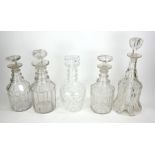 A COLLECTION OF FIVE 19TH CENTURY AND LATER CUT GLASS DECANTERS Comprising of one bell form, two