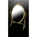 ARTS & CRAFTS, A VICTORIAN BRASS DRESSING TABLE MIRROR Having an oval bevelled glass swivel