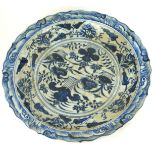 A LARGE CHINESE BLUE AND WHITE SHALLOW BOWL With cartouche border, decorated with clouds and