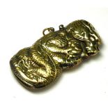 A BRASS 'DRAGON' NOVELTY VESTA CASE Decorated with an embossed dragon clutching a ball, with