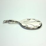 A SILVER NOVELTY HAND MIRROR Having Art Nouveau form design and pendant loop. (approx 7cm)