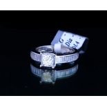 AN 18CT WHITE GOLD AND 1CT DIAMOND RING The central Princess cut diamond with baguette cut