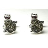 A PAIR OF STERLING SILVER AND MARCASITE 'CAT' GENT'S CUFFLINKS Seated pose with glass set eyes. (