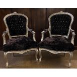 A PAIR OF FRENCH DESIGN SPOON BACK OPEN ARMCHAIRS With silvered frames upholstered in black button