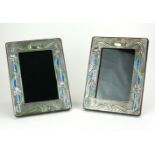 A PAIR OF SILVER AND ENAMEL ART NOUVEAU DESIGN PHOTO FRAMES Having organic form frame with blue