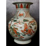 A LARGE 19TH CENTURY CHINESE FLARED NECK VASE Decorated with warriors and foliage on a bulbous body.