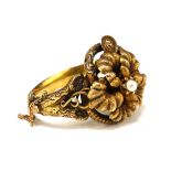 A 19TH CENTURY POLISH YELLOW METAL, DIAMOND AND PEARL BANGLE BRACELET The single South Sea Island