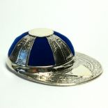 A SILVER NOVELTY JOCKEY CAP PIN CUSHION Having blue velvet cushion. (approx 5cm x 4cm)