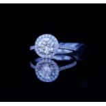 AN 18CT WHITE GOLD AND 1.28CT DIAMOND HALO RING The central round cut diamond edged with diamonds (