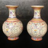 A LARGE PAIR OF CHINESE ARTICULATED VASES The flared necked floral decorated inner sleeves seated in
