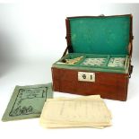 A CASED EARLY 20TH CENTURY CHINESE BAMBOO AND BONE MAHJONG SET The fitted brown leather carry case