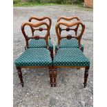 A SET OF FOUR WILLIAM IV CARVED ROSEWOOD SADDLE BACK CHAIRS With upholstered seats.