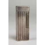 DUNHILL, A VINTAGE SILVER PLATED CIGARETTE LIGHTER Having a hinged lid and engine turned decoration.
