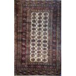 A BOKHARA WOLLEN RUG Having geometric design to central cream ground field, on red ground with