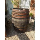 A LARGE EARLY 20TH CENTURY IRON BOUND COOPERED BARREL. (80cm x 110cm)