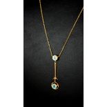 AN EDWARDIAN 9CT GOLD AND AQUAMARINE PENDANT NECKLACE Two round cut aquamarine stones in a