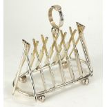 A SILVER PLATED NOVELTY TOAST RACK IN THE FORM OF CRICKET BATS AND BALLS. (19cm x 9cm x h 17cm)