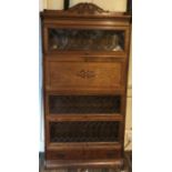 AN EARLY 20TH CENTURY OAK OXFORD MINTY STACKING BOOKCASE With secrétaire section and leaded glass