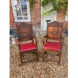 A PAIR OF NORTH COUNTRY OAK OPEN ARMCHAIRS With carved panelled backs, faux red leather