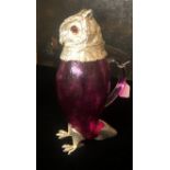 A SILVER PLATE AND RUBY GLASS CARAFE FORMED AS AN OWL With red glass eyes. (29cm) Condition: