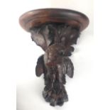A 19TH CENTURY SWISS CARVED OAK WALL BRACKET Finely carved with a bird of prey, beneath scrolling