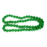 A CHINESE JADE NECKLACE Having a single strand of round jade beads. (each bead approx 1cm)