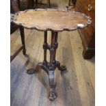 AN 18TH CENTURY DESIGN MAHOGANY OCCASIONAL TABLE The oval scalloped top raised on three turned