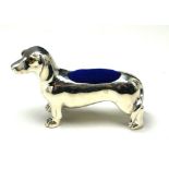 A STERLING SILVER NOVELTY 'DASCHHOUND' PIN CUSHION Standing pose with blue velvet cushion. (approx