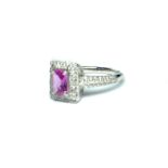 AN 18CT GOLD, PINK SAPPHIRE AND DIAMOND RING The baguette cut pink sapphire edged with diamonds. (