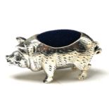 A STERLING SILVET NOVELTY 'PIG' PIN CUSHION Standing pose and having a blue velvet cushion. (