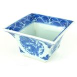 A CHINESE BLUE AND WHITE PORCELAIN SQUARE CUP Hand painted underglaze blue decoration of dragons and