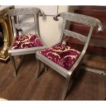 A PAIR OF ANGLO-INDIAN WHITE METAL CLAD CHAIRS With floral relief decoration, rams heads, cut velvet