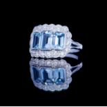 AN 18CT WHITE GOLD, AQUAMARINE AND DIAMOND CLUSTER RING The row of three baguette cut aquamarine