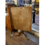 A GEORGIAN OAK TILT TOP RECTANGULAR OCCASIONAL TABLE On a turned column with splayed legs. (83cm x